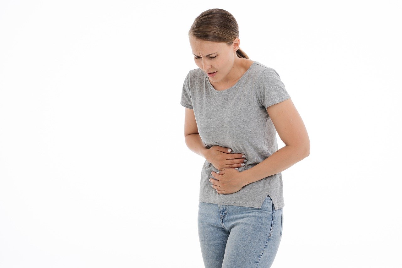 Woman holding abdomen indicating pain